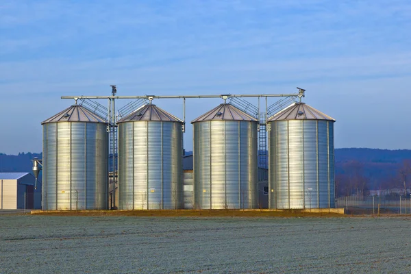 Silos in the middle of a field in wintertime Royalty Free Stock Images