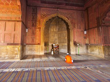 Man praying in the mosque Jama Masjid in Delhi clipart