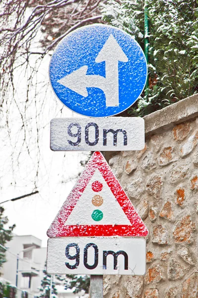 Traffic sign covered with snow indicates traffic light in 90 met — Stock Photo, Image