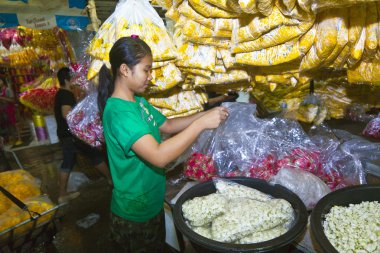 Women are selling fresh flowers at the morning market clipart