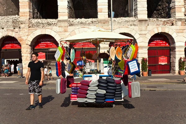 Seat cushions are sold in front of the famous old roman Arena of