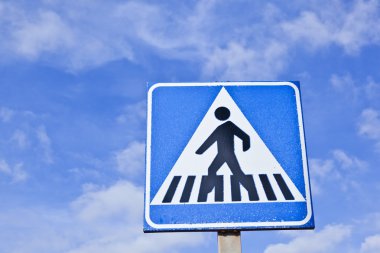 Pedestrian crossing sign with blue sky clipart