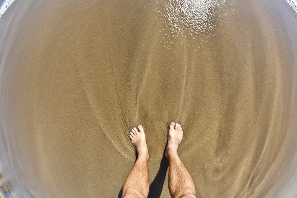 Ноги человека на пляже — стоковое фото