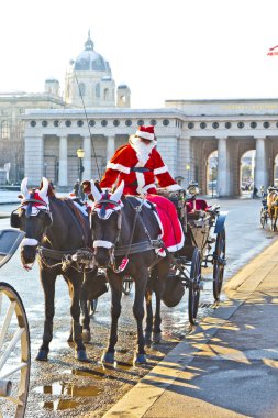 Driver of the fiaker is dressed as Santa Claus in red clipart