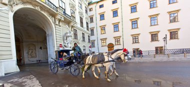 Horse drawn fiaker at the Hofburg for tourists in Vienna clipart