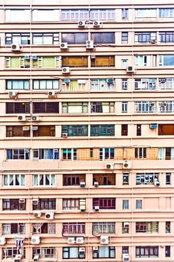 Iew to facade of old Skyscraper downtown Hong Kong clipart