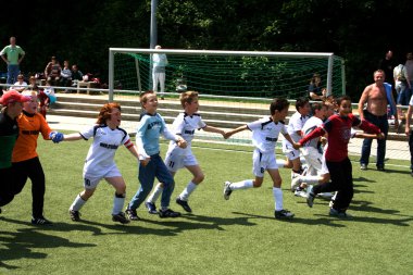 Children playing football clipart