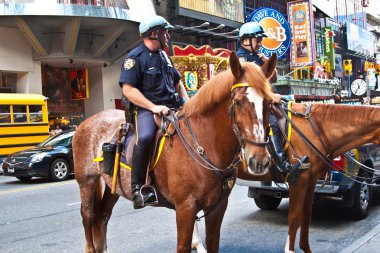 Policeofficer is riding his horse downtown New York clipart