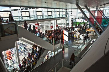 Visitors inside the fair hall on moving staircase clipart