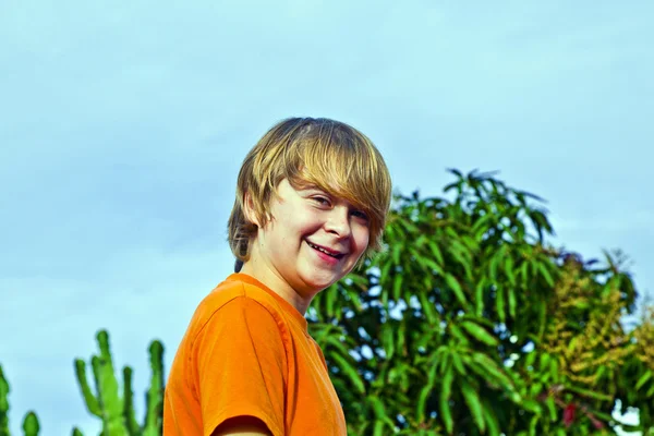 Mavi gökyüzü altında gülümseyerek mutlu çocuk — Stok fotoğraf