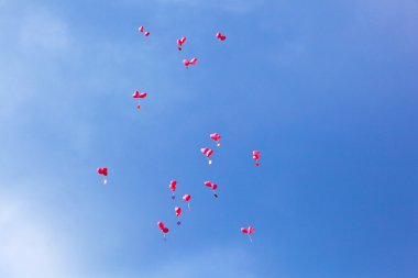 Red balloons with the messages in the blue sky clipart