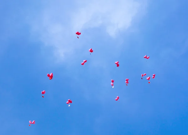 Rode ballonnen met berichten in de blauwe hemel — Stockfoto