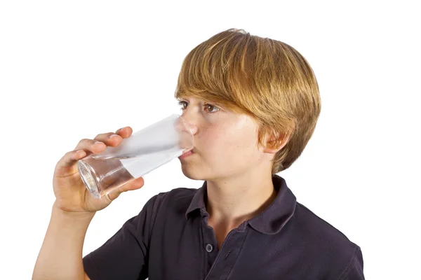 Boy drinking water out of a glass — Stock Photo, Image