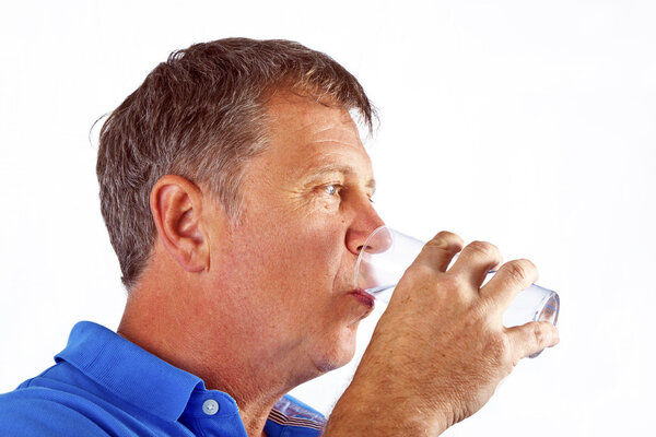 Man drinking water out of a glass