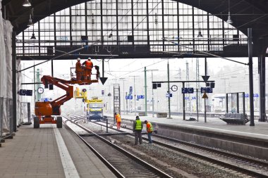 Worker repair the catenary in the station clipart