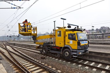 Worker repair the catenary in the station clipart