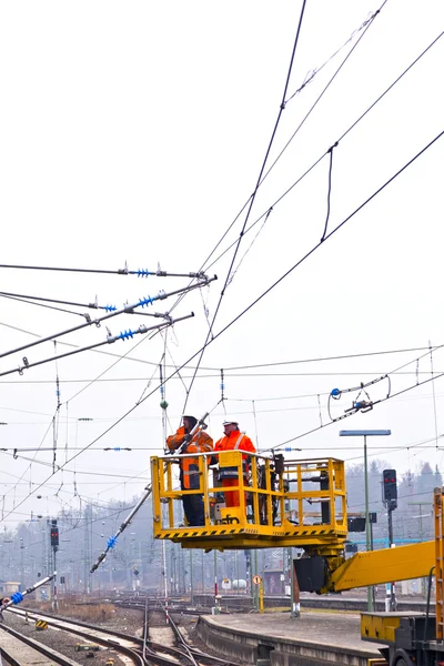 stock image Worker repair the catenary in the station