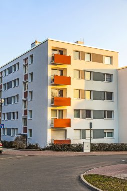 Apartment building with blue sky clipart