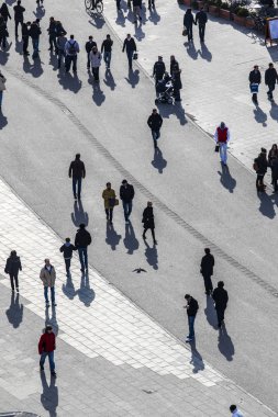 walking at the street with long shadows clipart