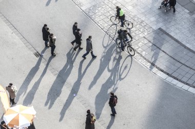 walking at the street with long shadows clipart