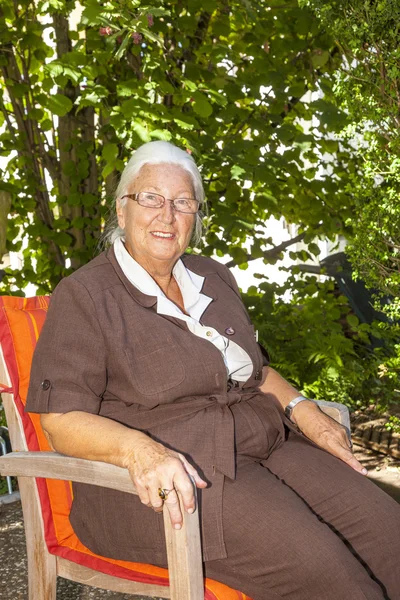 Mujer mayor disfruta sentado en su —  Fotos de Stock