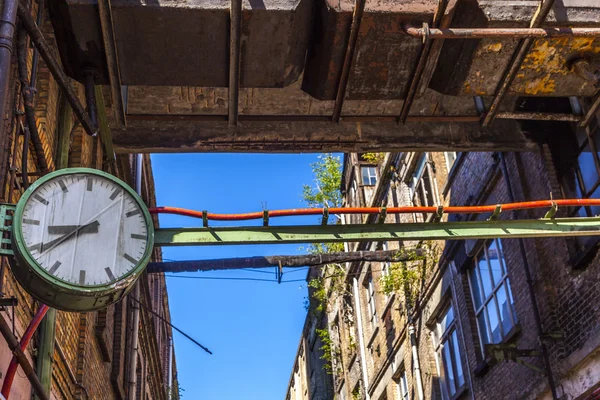 Zegar w starej opuszczonej fabryce w ścianie — Zdjęcie stockowe