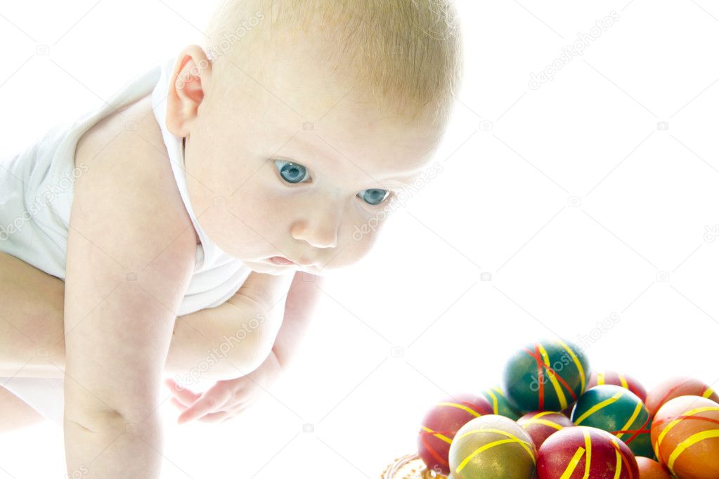 Blue-eyed child and colored easter eggs