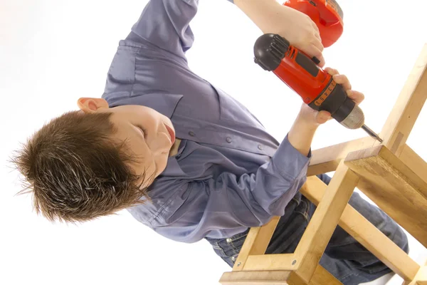 stock image Child with a screwdriver engaged in assembling furniture