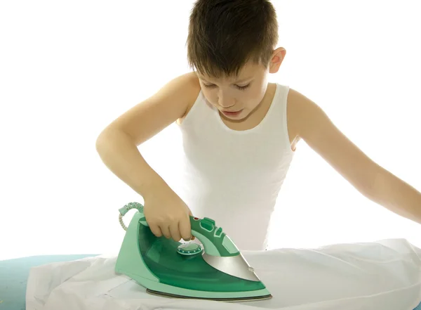 Мальчик гладит рубашку, изолированную на белом — стоковое фото