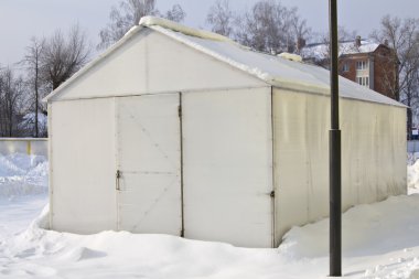 White metal hangar in winter clipart