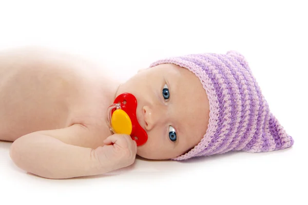 Baby with red pacifier — Stock Photo, Image