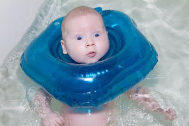 Baby swimmer with rubber ring clipart