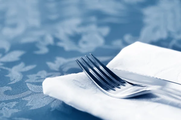 Cutlery on White Linen Over Brocade — Stock Photo, Image