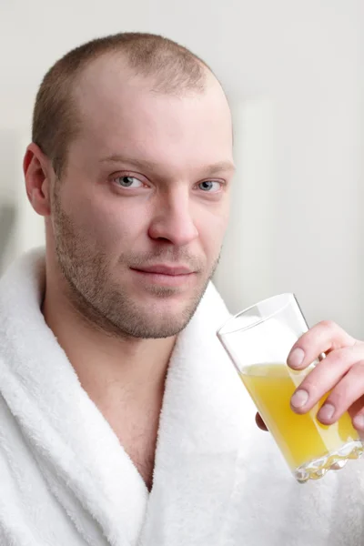 stock image Young man with orange jucie