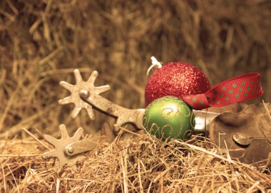 Cowboy Christmas - set of old rusty spurs with Christmas ornaments clipart