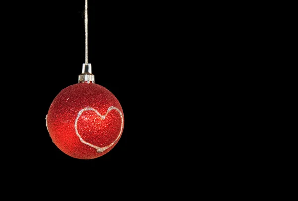 A simple image of a red glittery Christmas ornament with a silver heart — Stock Photo, Image