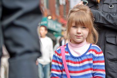 Young girl's face in crowd clipart