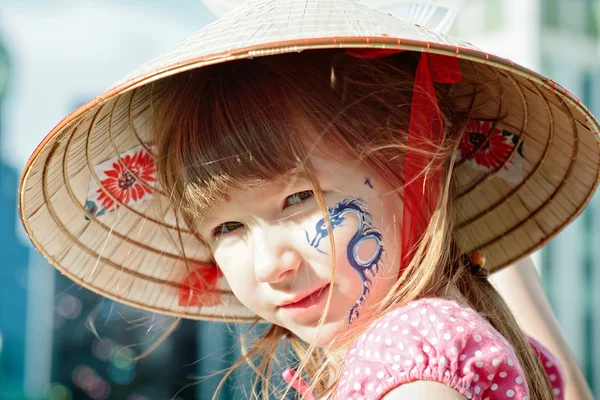 Portrait of a little girl with blue dragon on her cheek — Stock Photo, Image