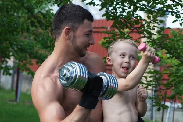 stock image Father and son train with dumbbells