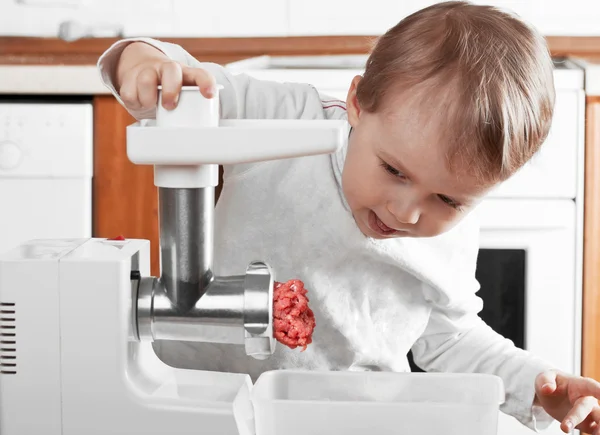 Little boy cutting meat — Stock Photo, Image