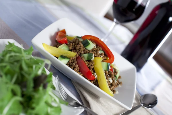 Вегетарианский салат из чечевицы и вино — стоковое фото
