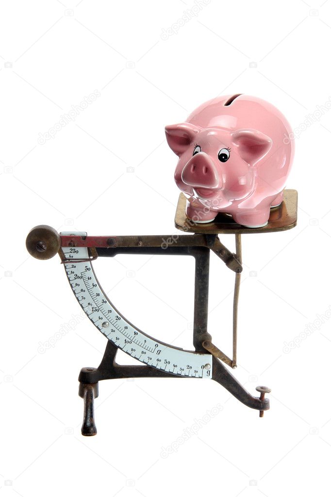Piggybank on old letter scales