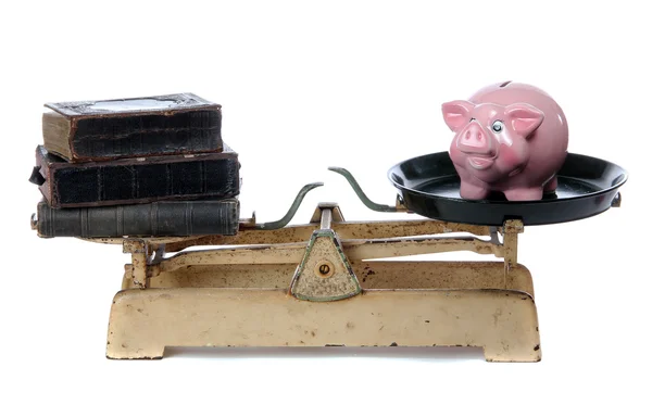 Books and piggy bank on scale — Stock Photo, Image