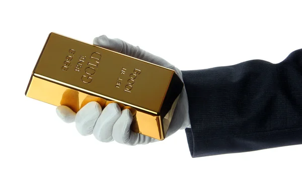 Hand mit Handschuh mit Goldbarren — Stockfoto