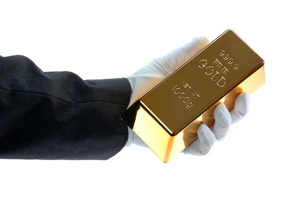 Hand with glove holding a gold bar — Stock Photo, Image