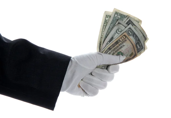Mano con guante sosteniendo montón de dólares — Foto de Stock