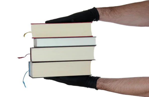 Stack of books in hands with black gloves — Stock Photo, Image