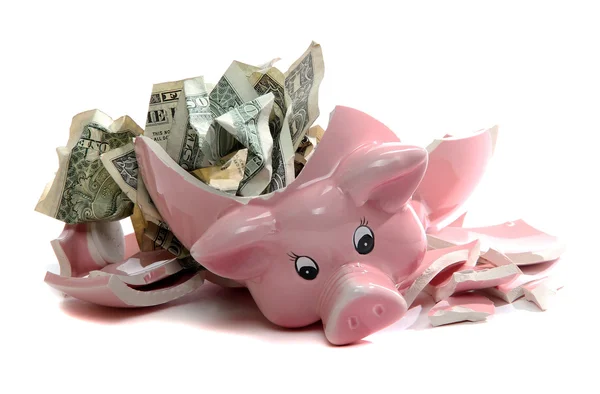 Piggybank quebrado com notas de dólar Fotos De Bancos De Imagens