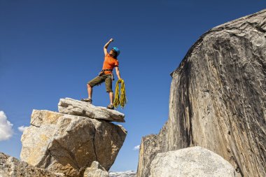 Climber on the summit. clipart