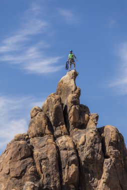 Climber on the summit. clipart